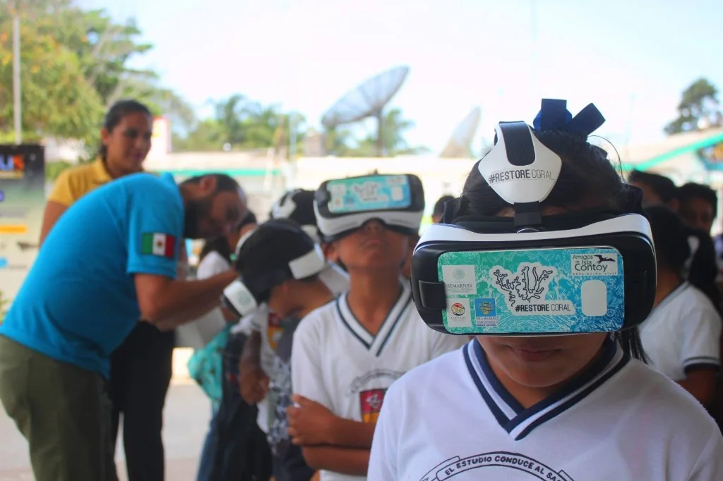Schoolchildren wearing Restore Coral virtual reality headsets during an education session